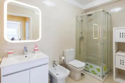 a bathroom with a toilet and a sink and a shower at O´Porto Fontinha Flat in Porto