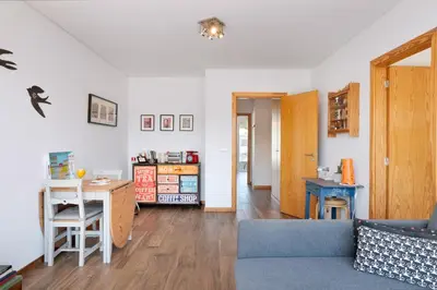a living room with a blue couch and a table at O´Porto Fontainhas Flat in Porto