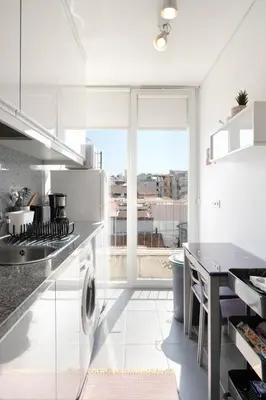 a kitchen with white appliances and a large window at O´Porto Fontainhas Flat in Porto