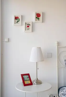 a lamp on a table with a book and pictures at O´Porto Fontainhas Flat in Porto