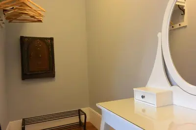 a bathroom with a mirror and a white dresser at Bonjardim 466 - Historic Townhouse in Porto