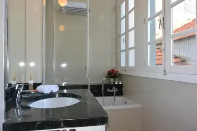 a bathroom with a sink and a window at Bonjardim 466 - Historic Townhouse in Porto