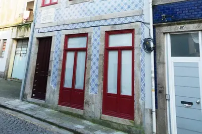 two red doors on the side of a building at Artury Porto in Porto
