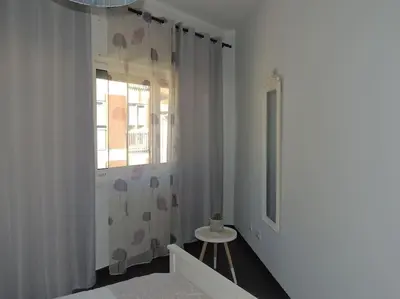 a white room with a table and a window at Rendez Vous Porto II in Porto