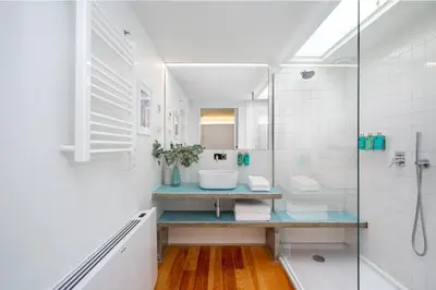 a white bathroom with a sink and a shower at Villa Almada - Amazing City Centre Villa with Private Pool in Porto