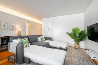 a living room with a couch and a tv at Villa Almada - Amazing City Centre Villa with Private Pool in Porto