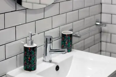 a bathroom sink with two soap dispensers on it at Alto da Lapa House w Parking by LovelyStay in Porto