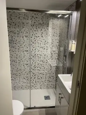 a bathroom with a shower with a toilet and a sink at CC Downtown Palace - A in Porto