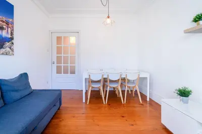 a living room with a blue couch and a table at Host Wise - Spacious Comfortable Apartment - Balcony in Porto