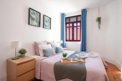 a bedroom with a bed with a tray on it at Host Wise - Spacious Comfortable Apartment - Balcony in Porto
