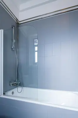 a shower with a glass door in a bathroom at Host Wise - Spacious Comfortable Apartment - Balcony in Porto