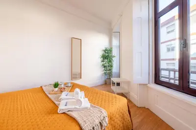 a bedroom with a bed with towels on it at Host Wise - Spacious Comfortable Apartment - Balcony in Porto