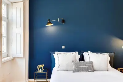 a blue bedroom with a bed with white pillows at DA'HOME - Boavista Blue Studio - NEW in Porto