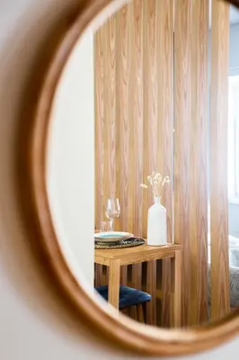 a mirror reflection of a table with a vase on it at DA'HOME - Boavista Blue Studio - NEW in Porto