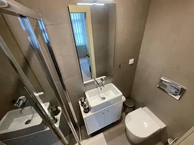 a bathroom with a sink and a toilet and a mirror at CC Downtown Palace - E in Porto