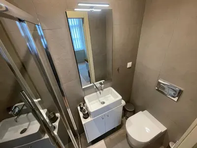 a bathroom with a sink and a toilet and a mirror at CC Downtown Palace - E in Porto