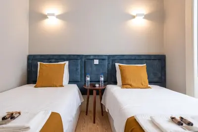 two beds sitting next to each other in a room at CC Downtown Palace - E in Porto