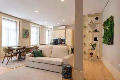 a living room with a white couch and a table at CC Downtown Palace - H in Porto