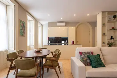 a living room with a white couch and a table at CC Downtown Palace - H in Porto