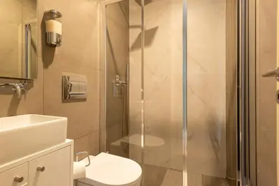 a bathroom with a shower and a toilet and a sink at CC Downtown Palace - I in Porto