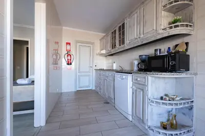 a kitchen with white cabinets and a microwave at MyRiverPlace River View Porto apartments in Vila Nova de Gaia