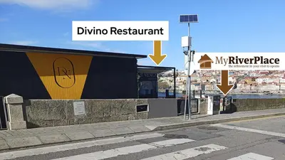 a street sign next to a building on a city street at MyRiverPlace River View Porto apartments in Vila Nova de Gaia