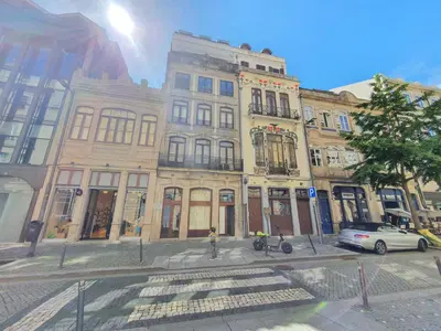 a building on a city street with a car parked in front at SantOporto Clérigos in Porto