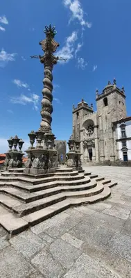 a statue in front of a building with stairs at SantOporto Clérigos in Porto