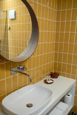 a bathroom with a sink and a mirror at Adega Floresta Residence in Porto