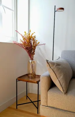 a vase on a table next to a couch at Adega Floresta Residence in Porto
