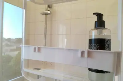 a bottle of soap sitting on a shelf in a bathroom at Rian - central 2 bedroom Apartment in Porto in Porto