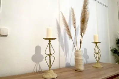 a table with two candles and two vases on it at Rian - central 2 bedroom Apartment in Porto in Porto