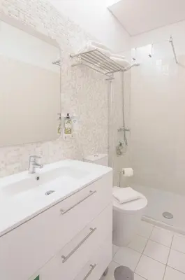 a white bathroom with a sink and a toilet at Bolhão - Dixo's Oporto Apartments VIII in Porto