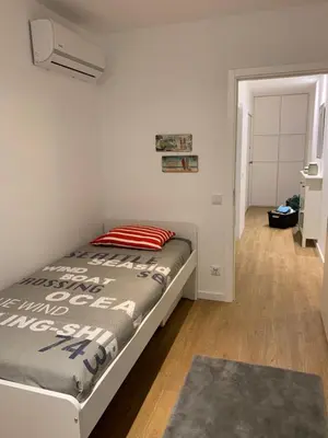 a bedroom with a bed and a hallway with a door at Palace House Apartment in Porto