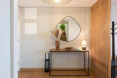 a hallway with a table and a mirror at Modern Loft with AC in Downtown Porto by LovelyStay in Porto