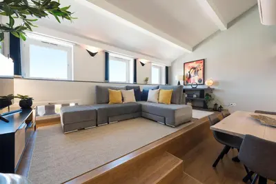a living room with a couch and a table at Modern Loft with AC in Downtown Porto by LovelyStay in Porto