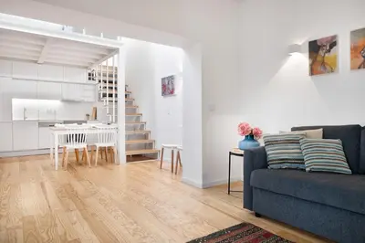 a living room and kitchen with a couch and a table at Oporto Classic Terrace in Porto