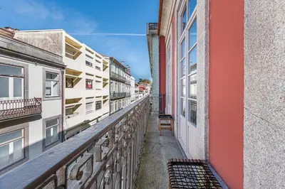 an alley between two buildings with a chair on it at GuestReady - The Art of Music in Porto