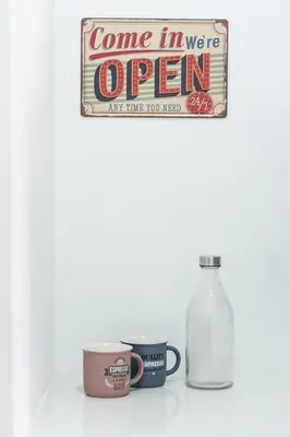a shelf with two coffee cups and a bottle of water at GuestReady - The Art of Music in Porto