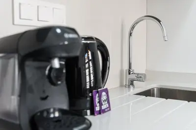 a kitchen counter with a coffee maker sitting on a kitchen counter sidx sidx at GuestReady - The Art of Music in Porto