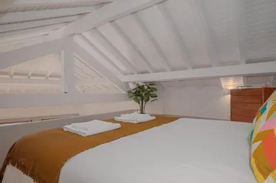 a white room with a bed with towels on it at Oporto Artist´s Loft in Porto