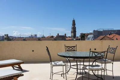 a table and chairs on the roof of a building at Best rooftop in Porto! in Porto