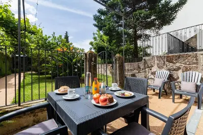 a table with food on it on a patio at Casa de Arouca Porto Apartments in Porto