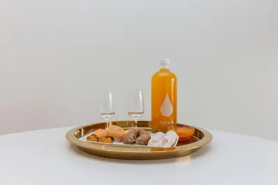 a tray of food with two wine glasses and a bottle at Casa de Arouca Porto Apartments in Porto