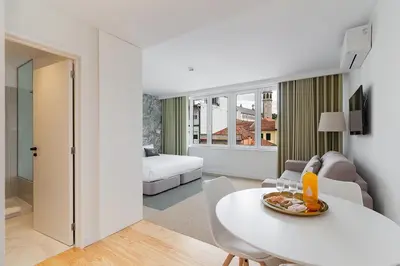 a living room with a white table and a couch at Casa de Arouca Porto Apartments in Porto