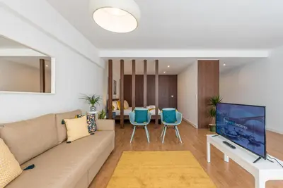 a living room with a couch and a tv at GuestReady - Hemisphere Apt in Porto