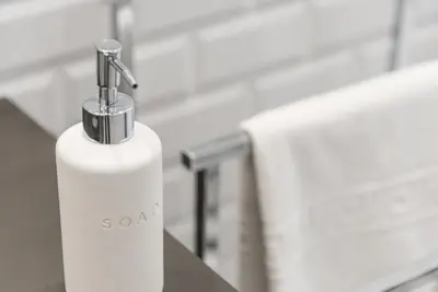 a white soap dispenser sitting on a table at GuestReady - Hemisphere Apt in Porto