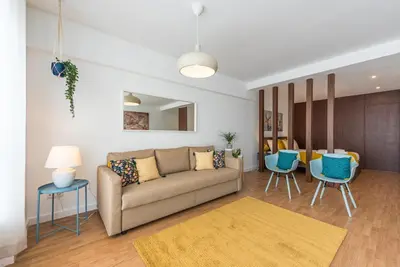 a living room with a couch and blue chairs at GuestReady - Hemisphere Apt in Porto