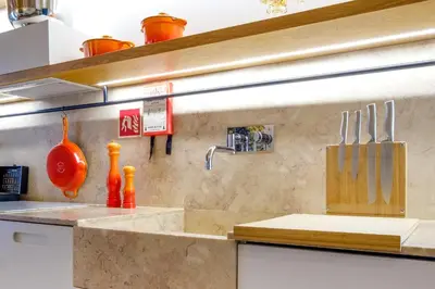 a kitchen with a counter with a cutting board and utensils at The Bitcoin Chapel Iconic Luxury Residence in Porto