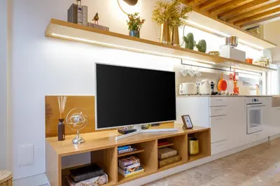 a living room with a flat screen tv on a counter at The Bitcoin Chapel Iconic Luxury Residence in Porto